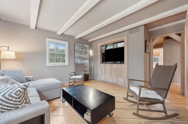 a living room with a flat screen tv and a fireplace