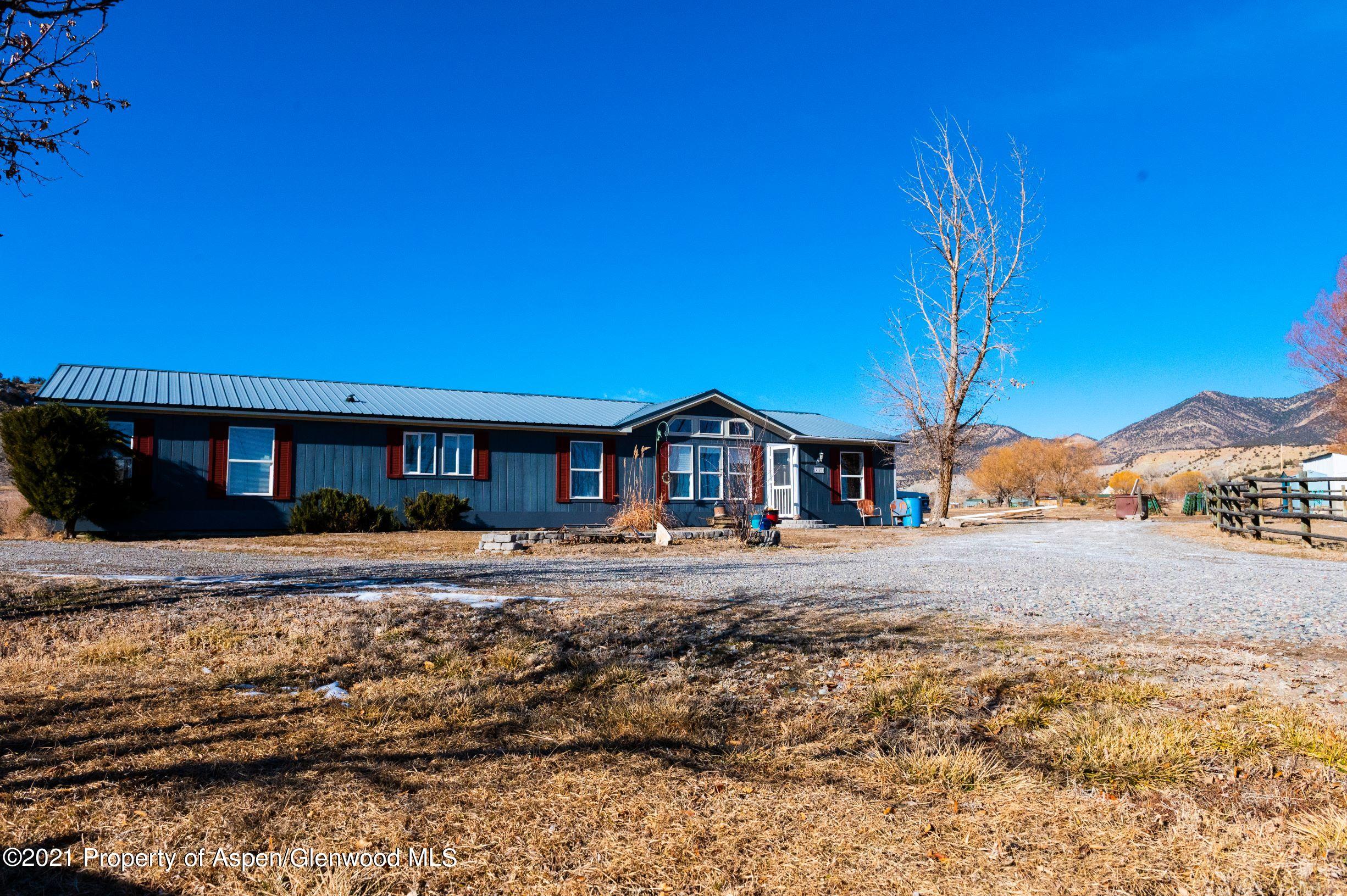 3171 County Road 233 Rifle, CO 81650 - Photo 1 of 36 a front view of a house with a yard