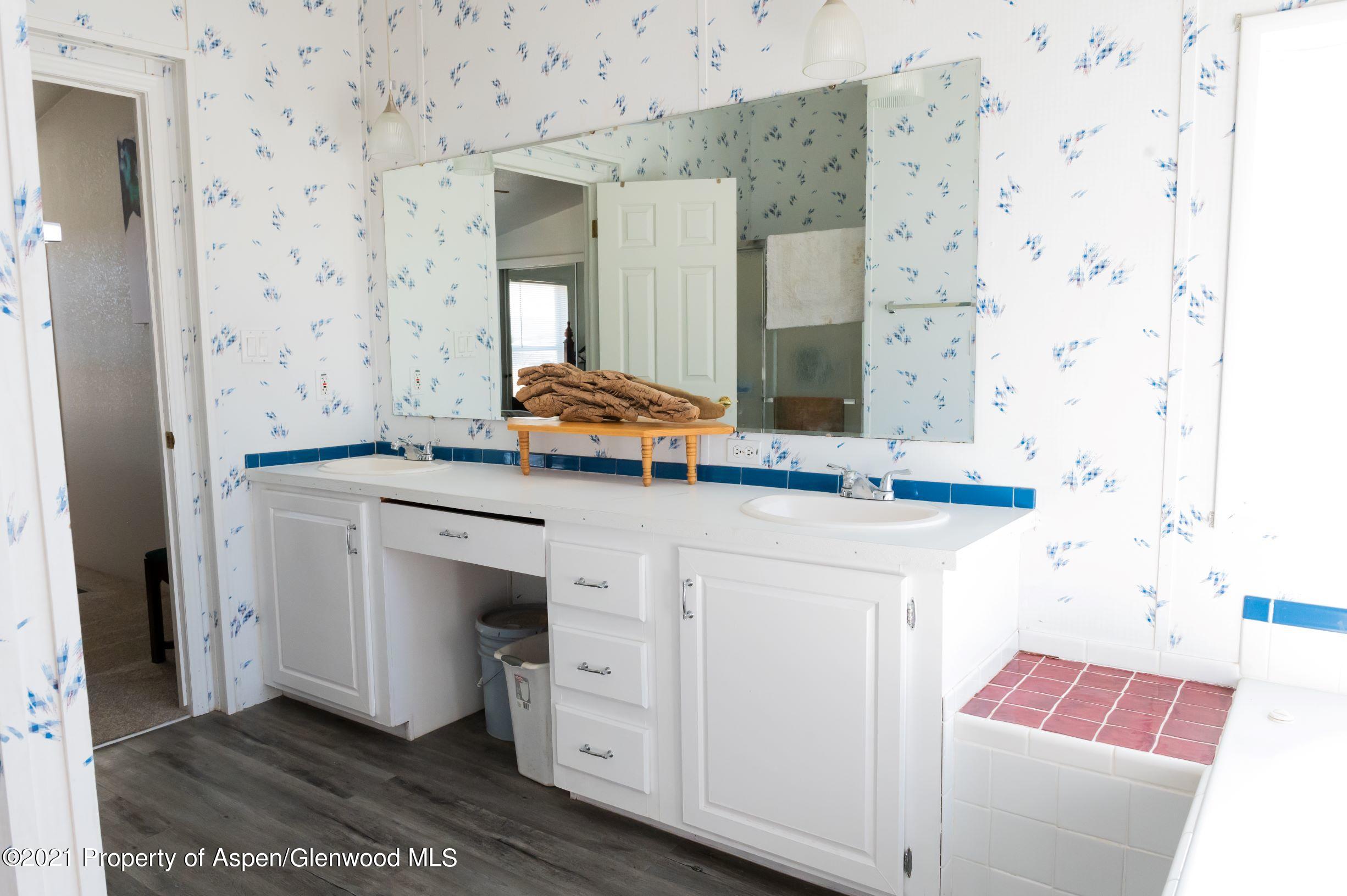 3171 County Road 233 Rifle, CO 81650 - Photo 13 of 36 a bathroom with a sink and a mirror