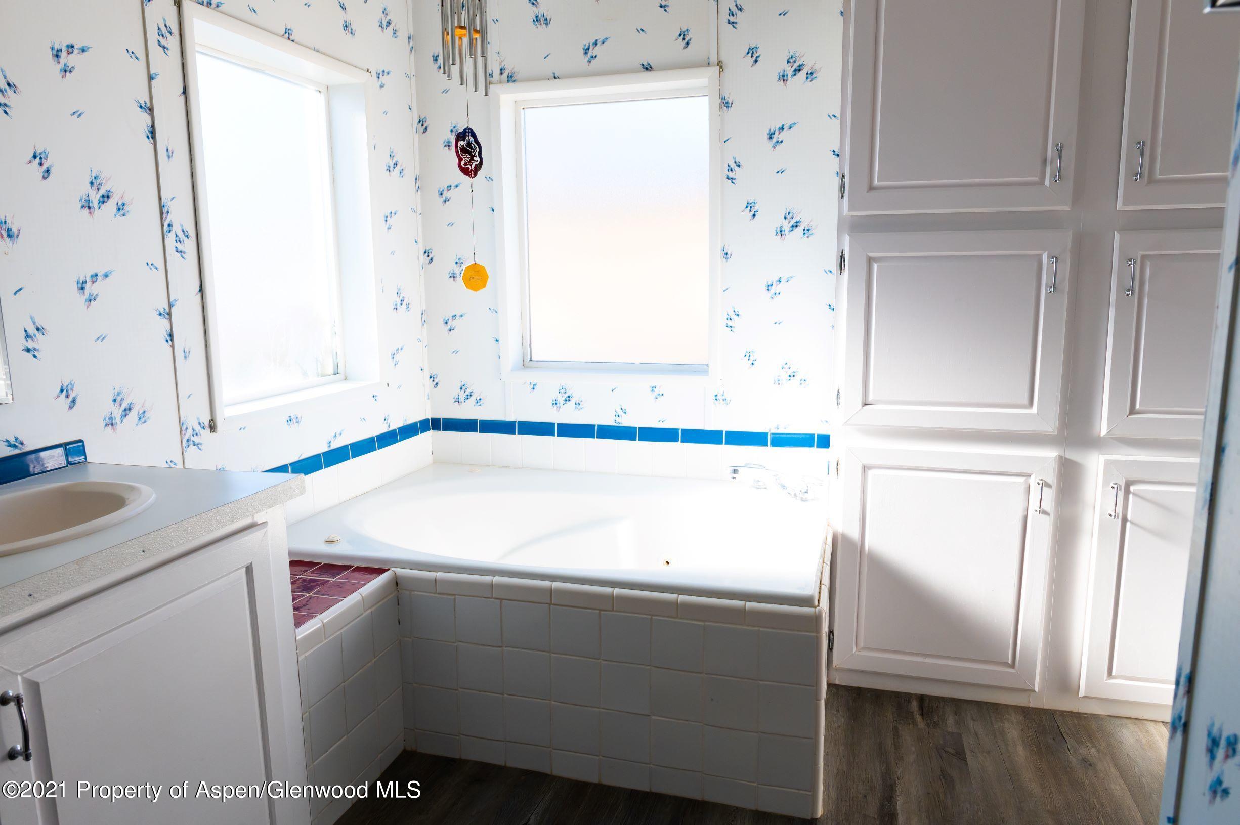 3171 County Road 233 Rifle, CO 81650 - Photo 14 of 36 a bathroom with a sink and a mirror