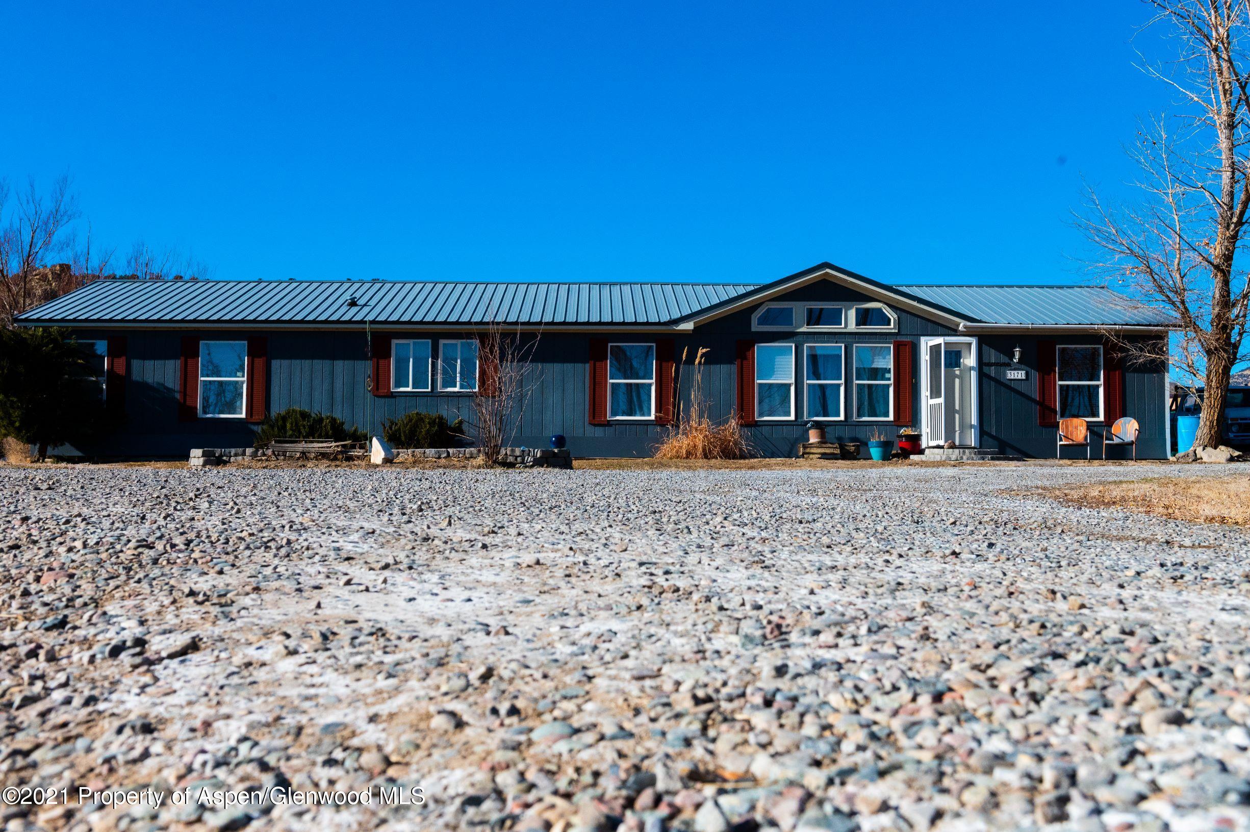 3171 County Road 233 Rifle, CO 81650 - Photo 2 of 36 a front view of a house with a yard