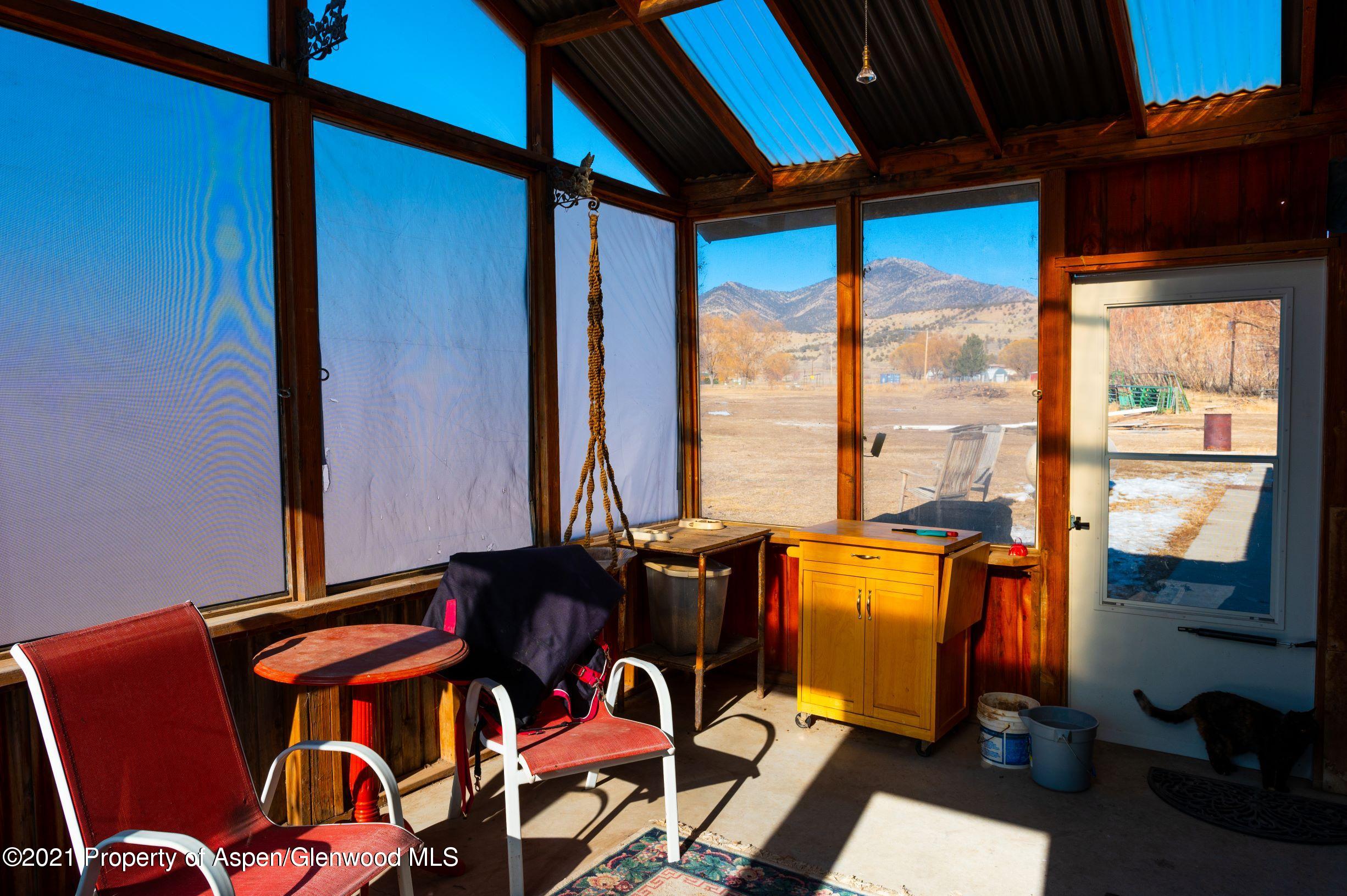3171 County Road 233 Rifle, CO 81650 - Photo 34 of 36 a blue bed sitting in a room next to a window
