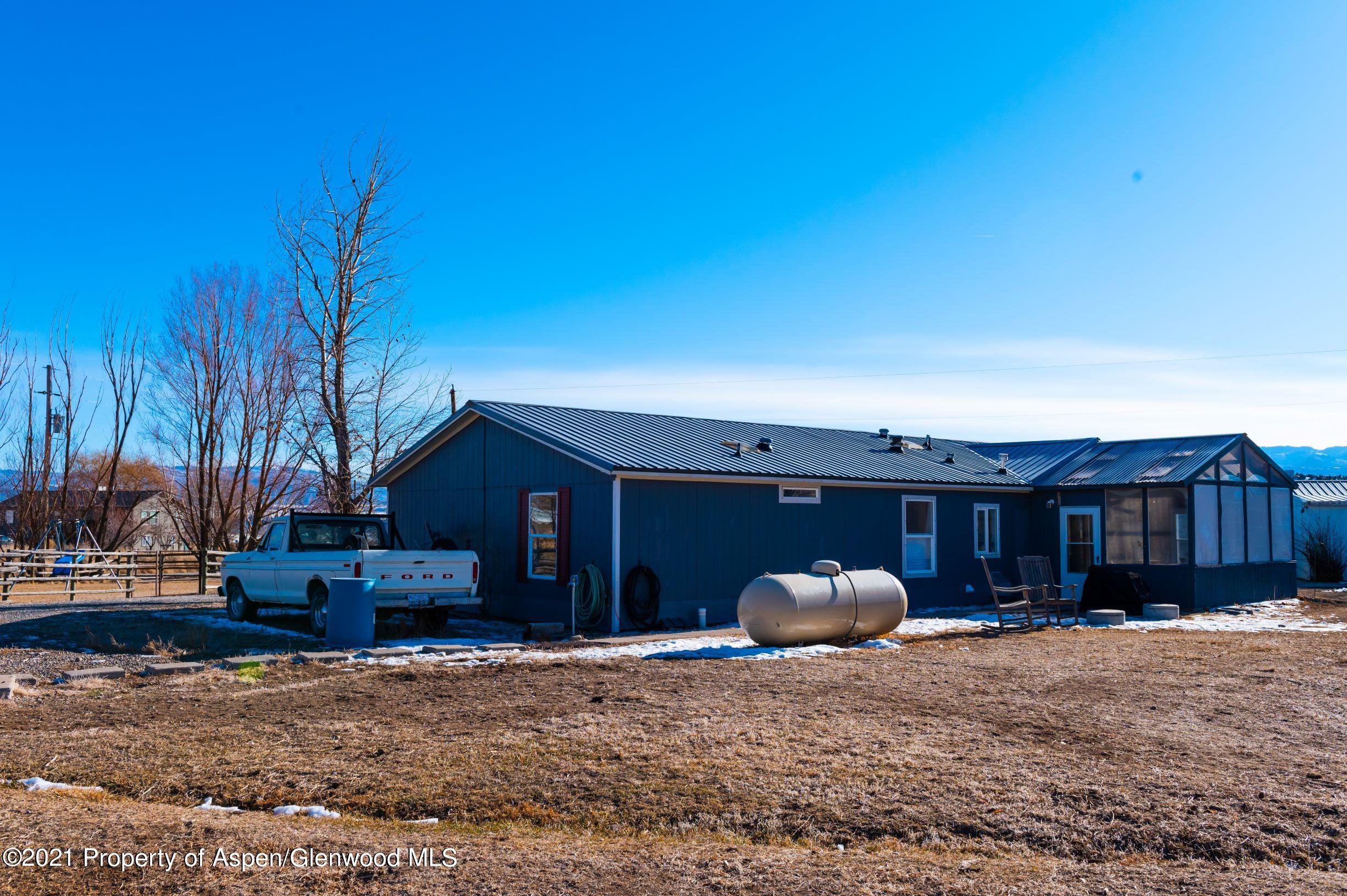 3171 County Road 233 Rifle, CO 81650 - Photo 36 of 36 a front view of a house with basket ball court