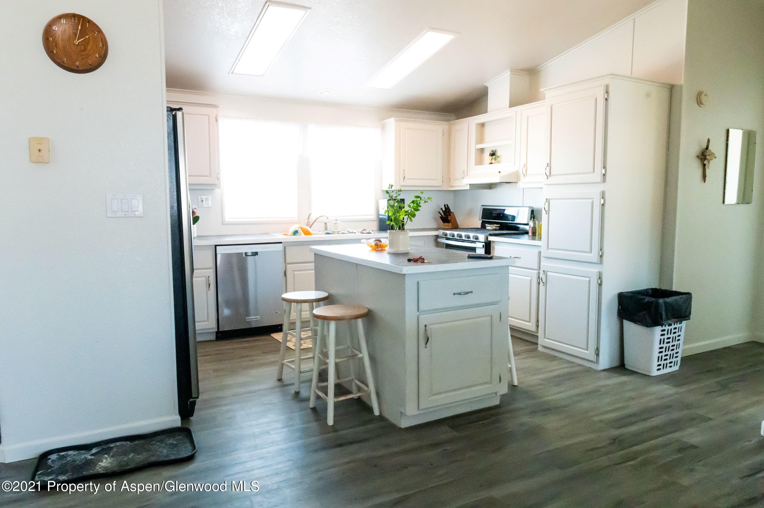 3171 County Road 233 Rifle, CO 81650 - Photo 5 of 36 a kitchen with a stove a refrigerator and a microwave