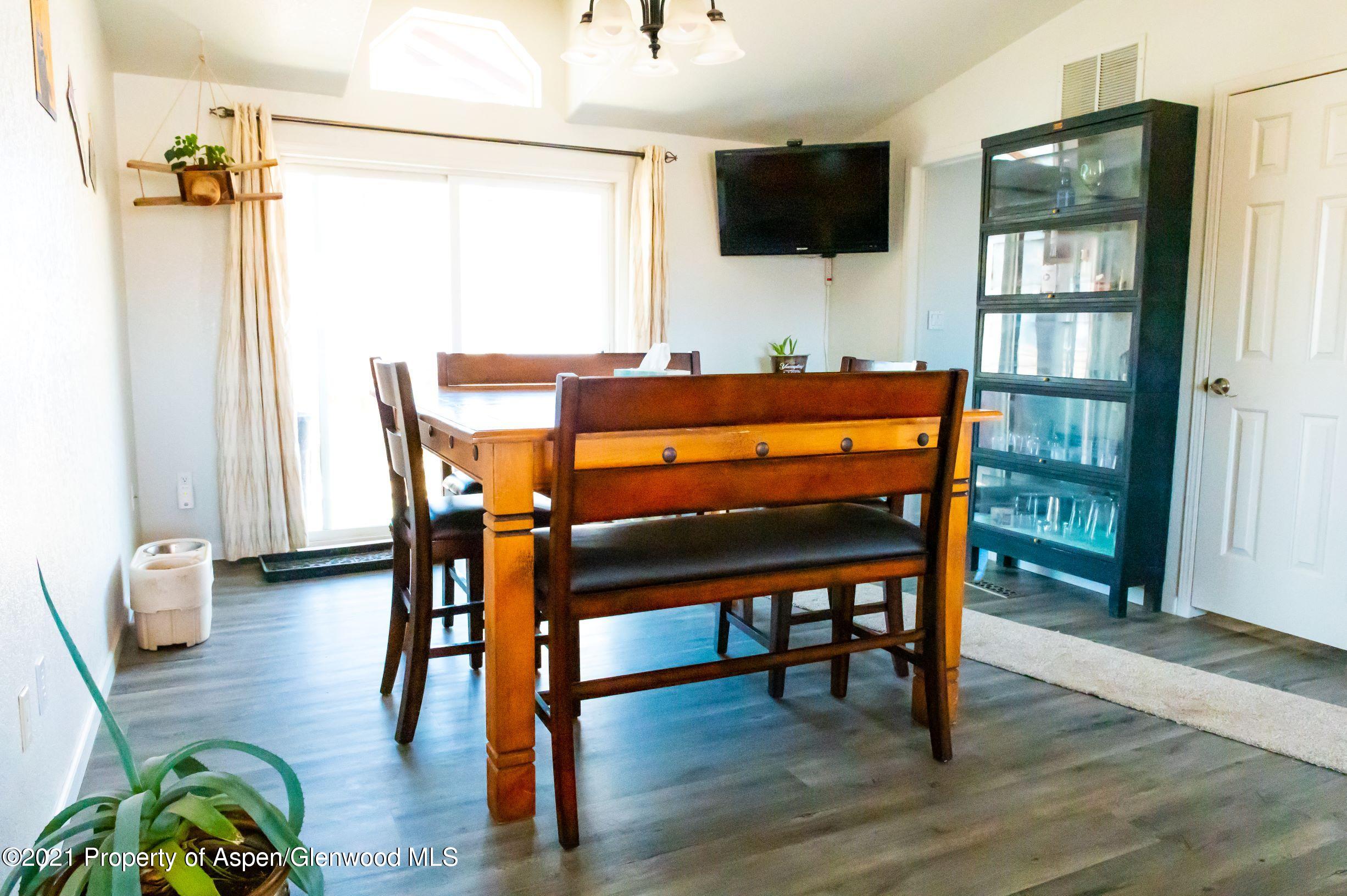 3171 County Road 233 Rifle, CO 81650 - Photo 6 of 36 a dining room with furniture and wooden floor