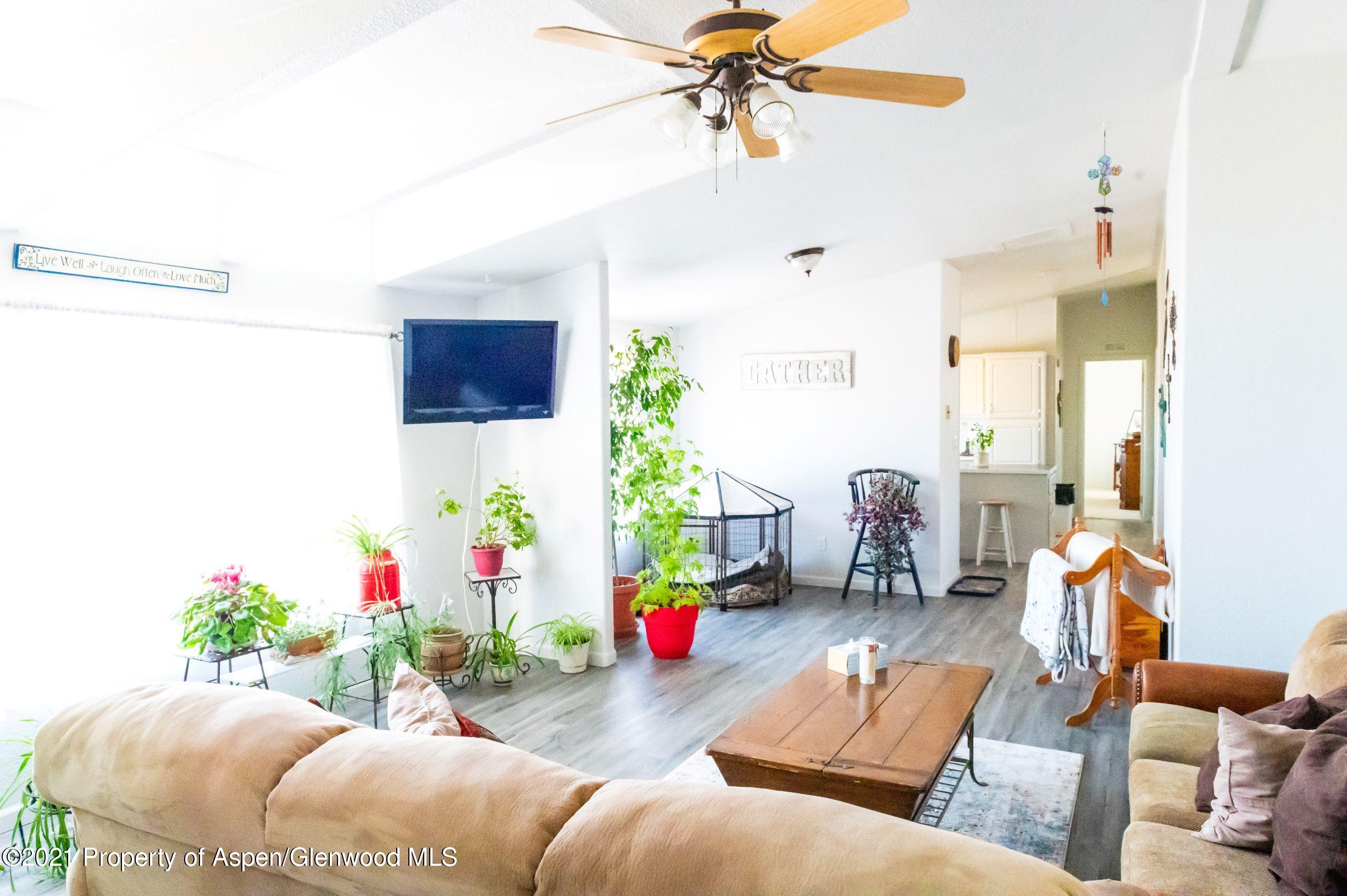 3171 County Road 233 Rifle, CO 81650 - Photo 10 of 36 a living room with furniture and flowers