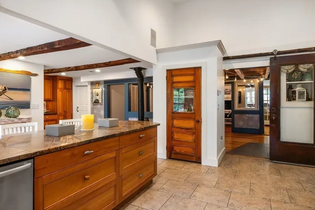 a spacious bathroom with a granite countertop sink and a mirror