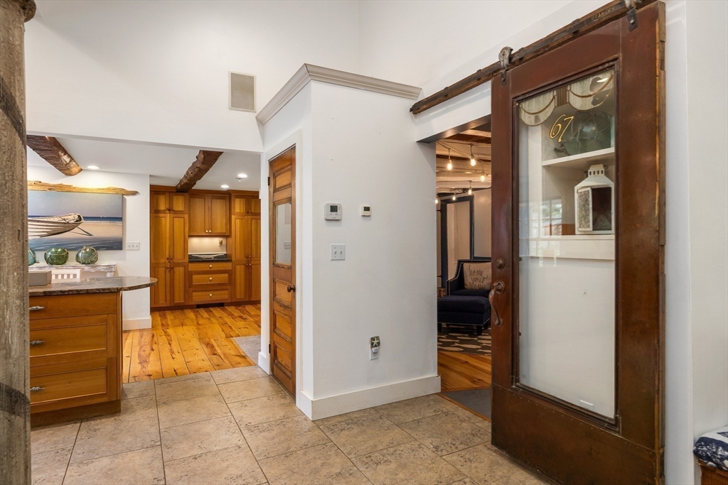 356 Main Street Amesbury, MA 01913 - Photo 14 of 41 a view of a hallway with dining area and chandelier