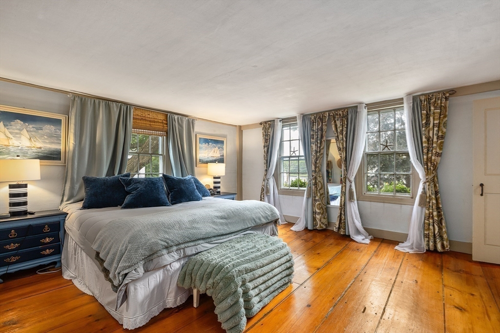 356 Main Street Amesbury, MA 01913 - Photo 26 of 41 a bedroom with a bed and large windows