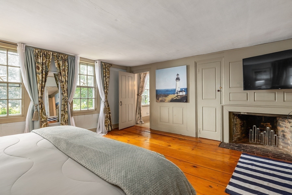 356 Main Street Amesbury, MA 01913 - Photo 27 of 41 a spacious bedroom with a bed and a flat screen tv