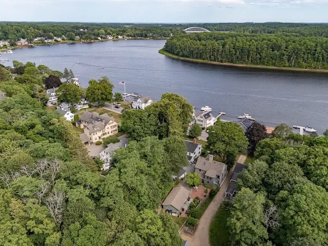 an aerial view of a house with outdoor space and lake view