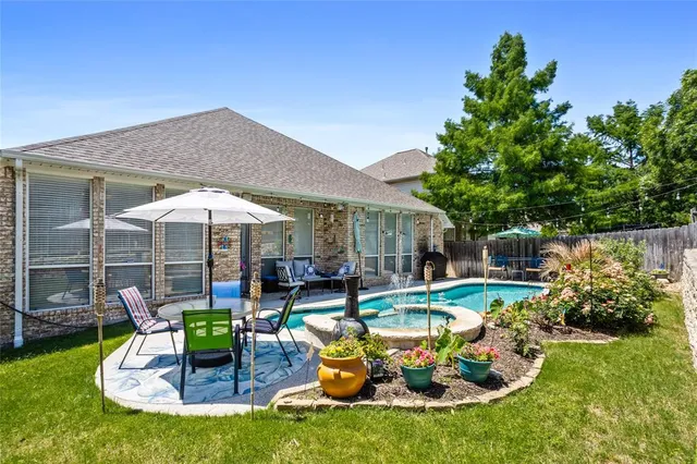 a view of a house with backyard outdoor seating area and furniture