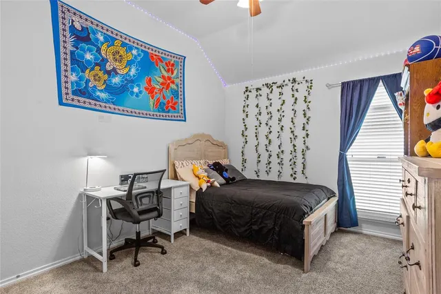 a bedroom with a bed a desk and chair