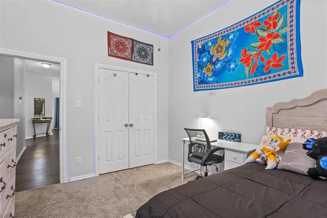 a bedroom with furniture and a painting on the wall