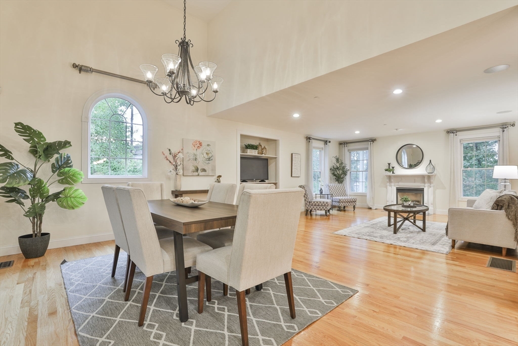 53 Cooper Street Wakefield, MA 01880 - Photo 11 of 42 a view of a dining room with furniture a chandelier and wooden floor