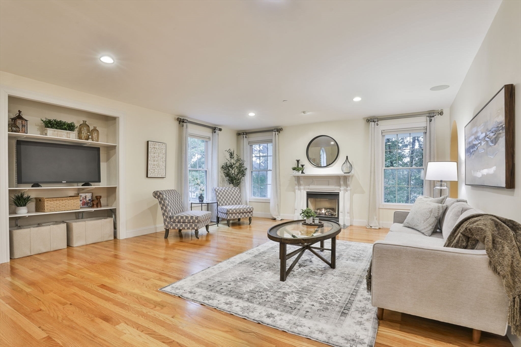 53 Cooper Street Wakefield, MA 01880 - Photo 12 of 42 a living room with furniture a fireplace and a flat screen tv