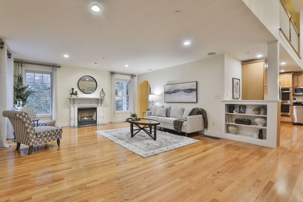 53 Cooper Street Wakefield, MA 01880 - Photo 13 of 42 a living room with furniture a fireplace and a dining table with wooden floor
