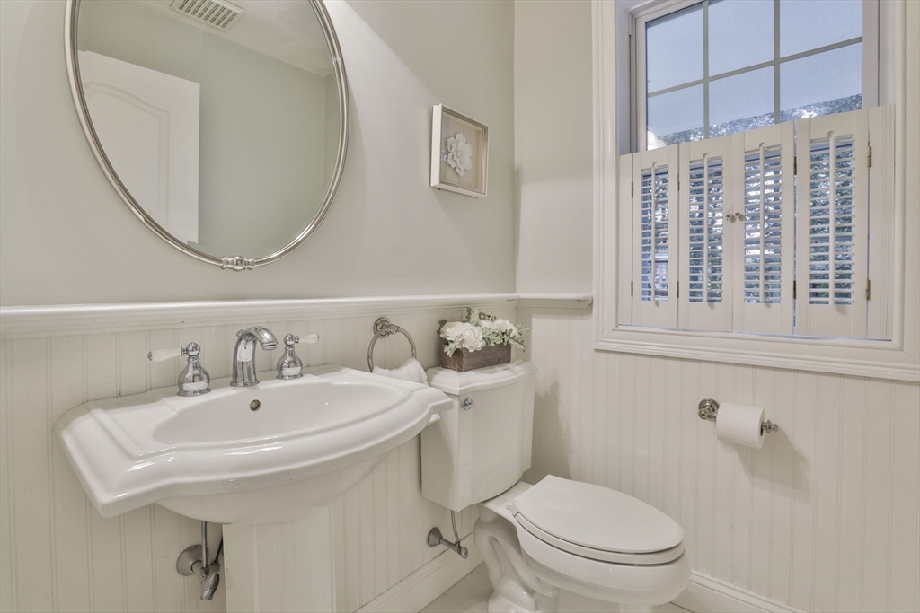 53 Cooper Street Wakefield, MA 01880 - Photo 14 of 42 a bathroom with a sink a toilet and a mirror