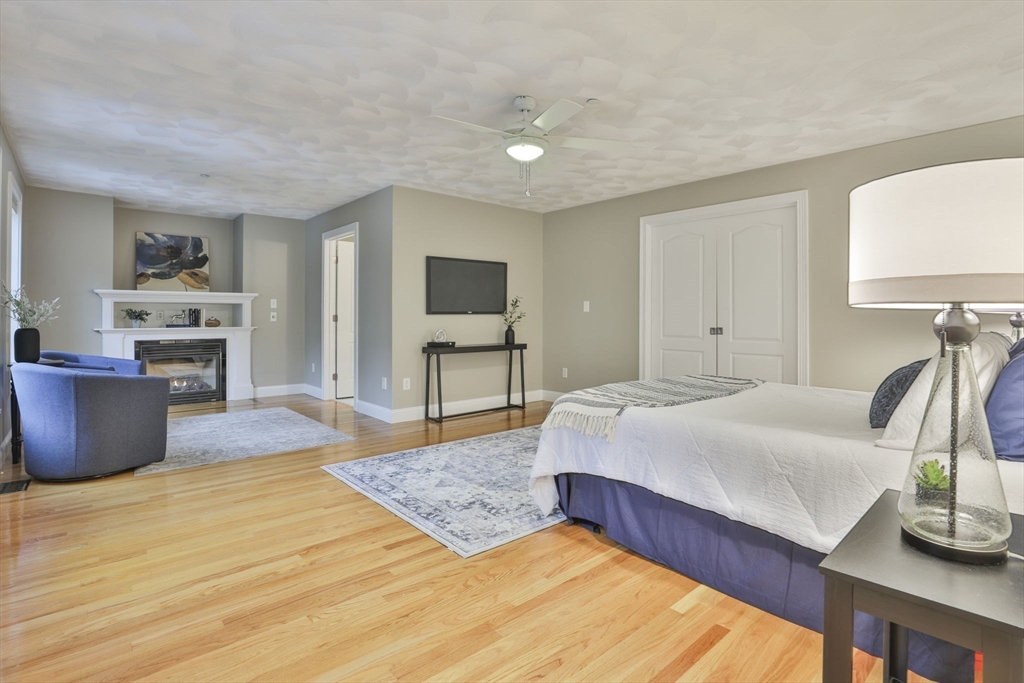 53 Cooper Street Wakefield, MA 01880 - Photo 15 of 42 a spacious bedroom with a bed and a table in it
