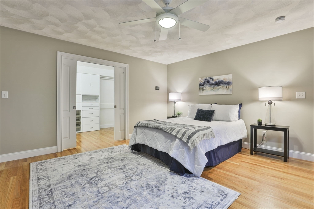 53 Cooper Street Wakefield, MA 01880 - Photo 17 of 42 a spacious bedroom with a bed and a lamp