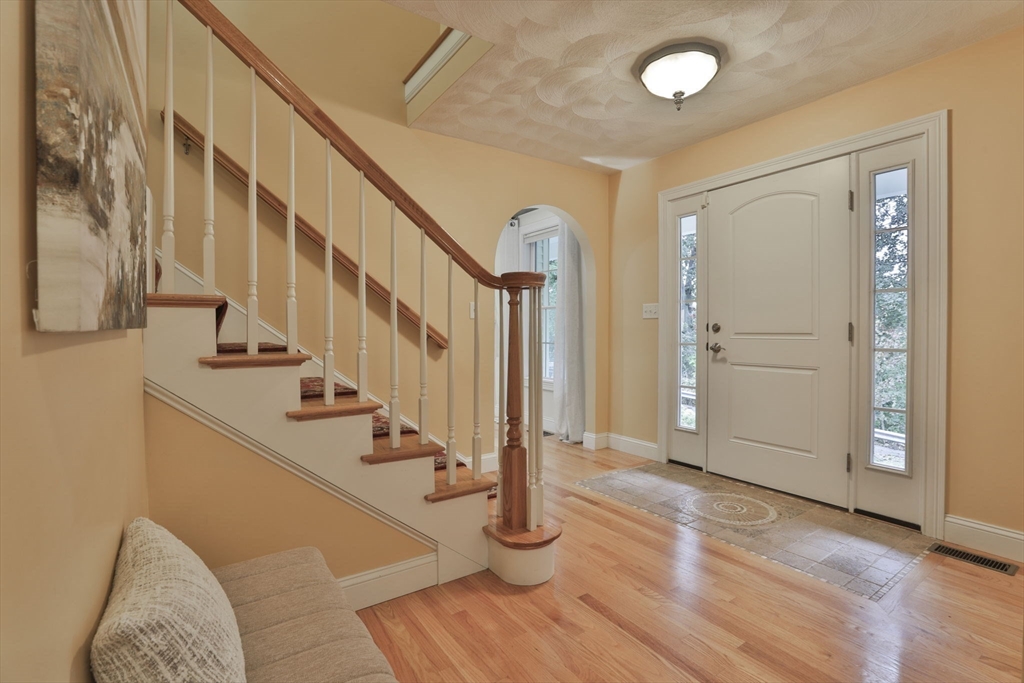 53 Cooper Street Wakefield, MA 01880 - Photo 2 of 42 a view of entryway with wooden floor and stairs