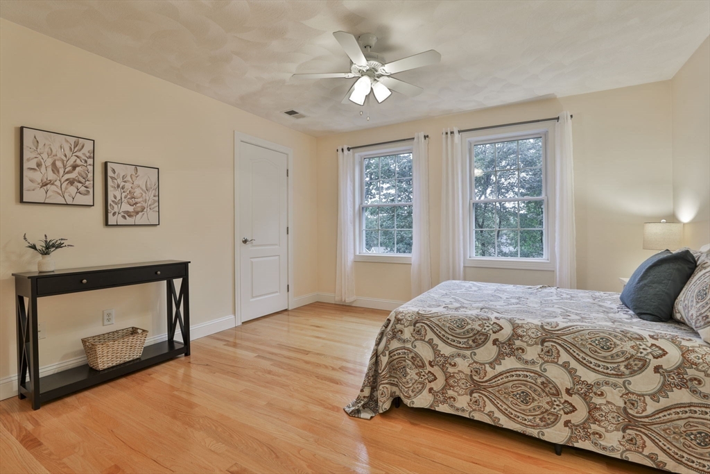 53 Cooper Street Wakefield, MA 01880 - Photo 24 of 42 a bedroom with a bed and a fireplace
