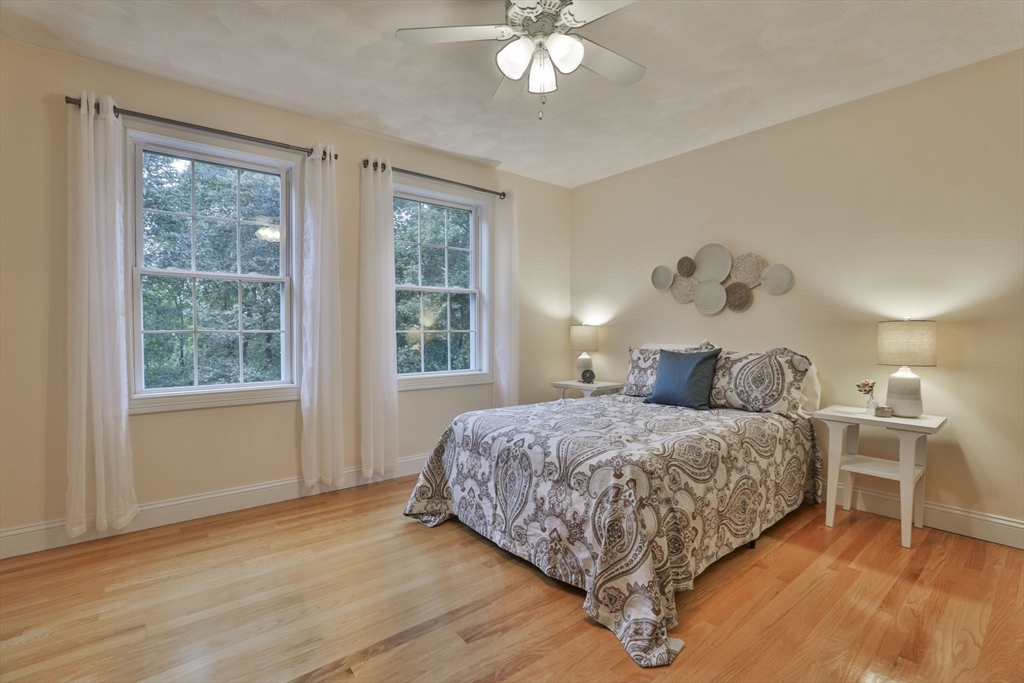 53 Cooper Street Wakefield, MA 01880 - Photo 25 of 42 a bedroom with a large bed and a chandelier