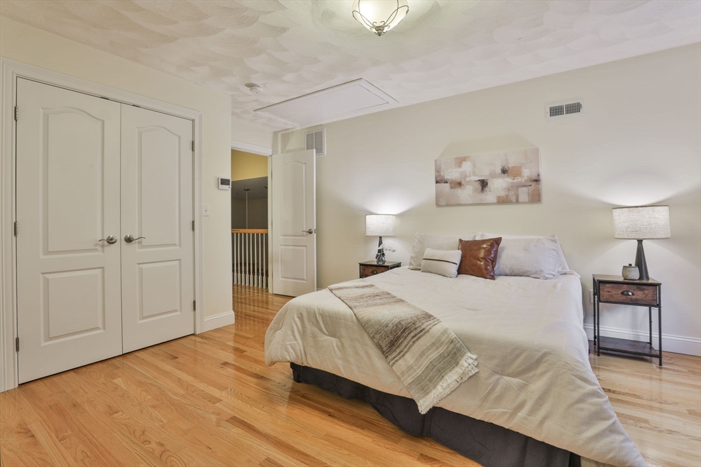 53 Cooper Street Wakefield, MA 01880 - Photo 28 of 42 a bedroom with a bed and a chandelier