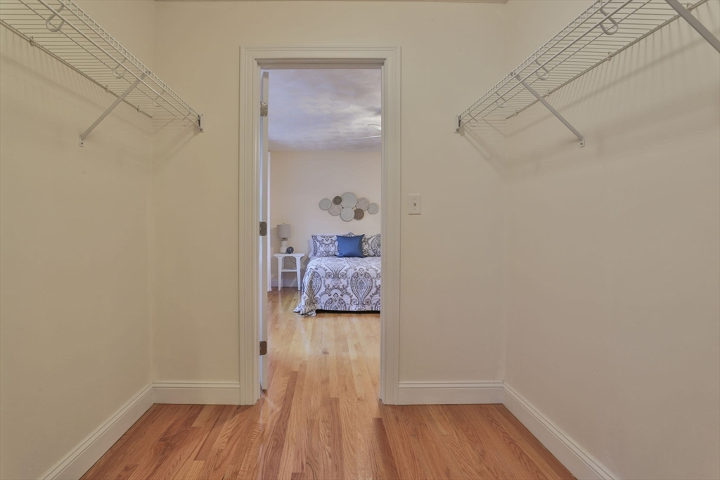 53 Cooper Street Wakefield, MA 01880 - Photo 29 of 42 a bedroom with a bed and wooden floor