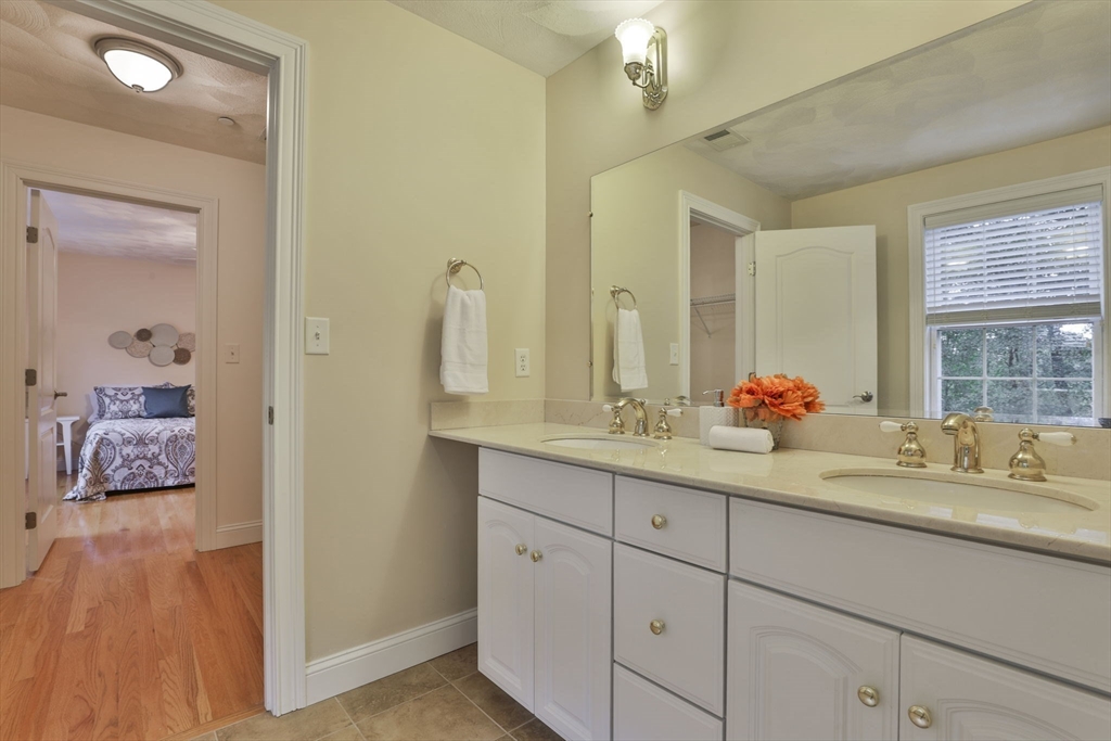 53 Cooper Street Wakefield, MA 01880 - Photo 30 of 42 a bathroom with a granite countertop double vanity sink and a mirror