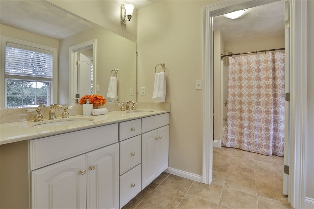 53 Cooper Street Wakefield, MA 01880 - Photo 31 of 42 a bathroom with a double vanity sink and mirror