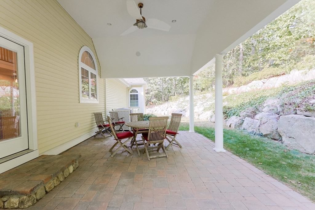 53 Cooper Street Wakefield, MA 01880 - Photo 38 of 42 a view of a porch with chairs and backyard