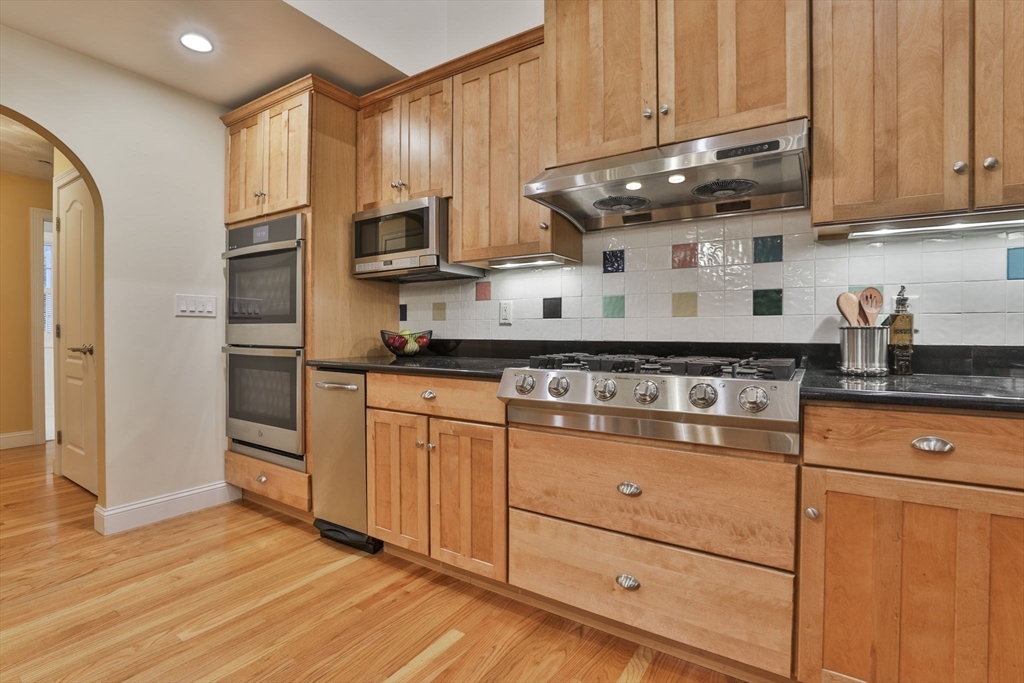 53 Cooper Street Wakefield, MA 01880 - Photo 5 of 42 a kitchen with stainless steel appliances granite countertop a stove a refrigerator and a microwave