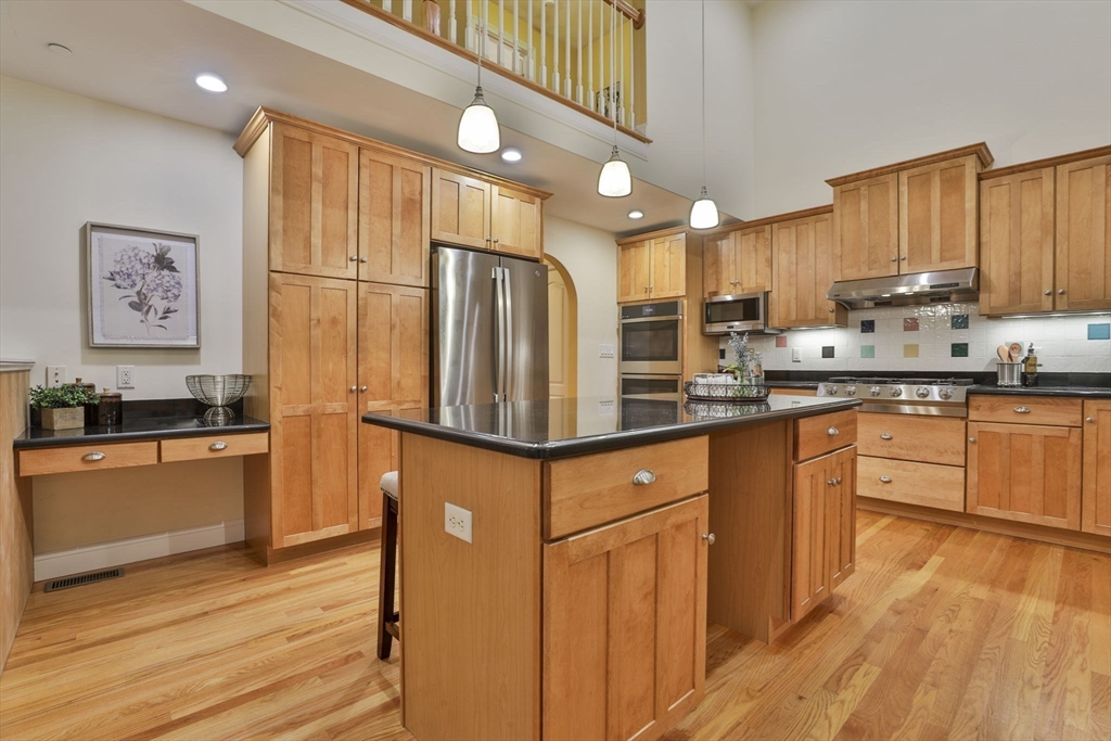 53 Cooper Street Wakefield, MA 01880 - Photo 8 of 42 a kitchen with stainless steel appliances granite countertop a refrigerator sink and cabinets