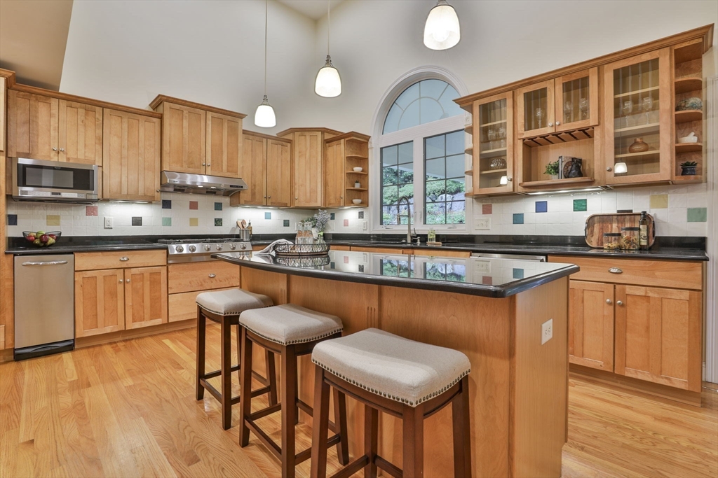53 Cooper Street Wakefield, MA 01880 - Photo 9 of 42 a kitchen with stainless steel appliances granite countertop a sink a stove counter space and cabinets