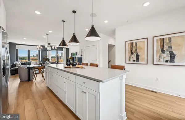 a kitchen with stainless steel appliances kitchen island granite countertop a sink a counter space and a center island