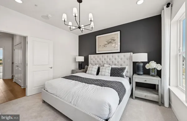 a bedroom with bed and a chandelier
