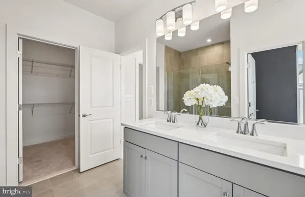 a bathroom with a double vanity sink and a mirror