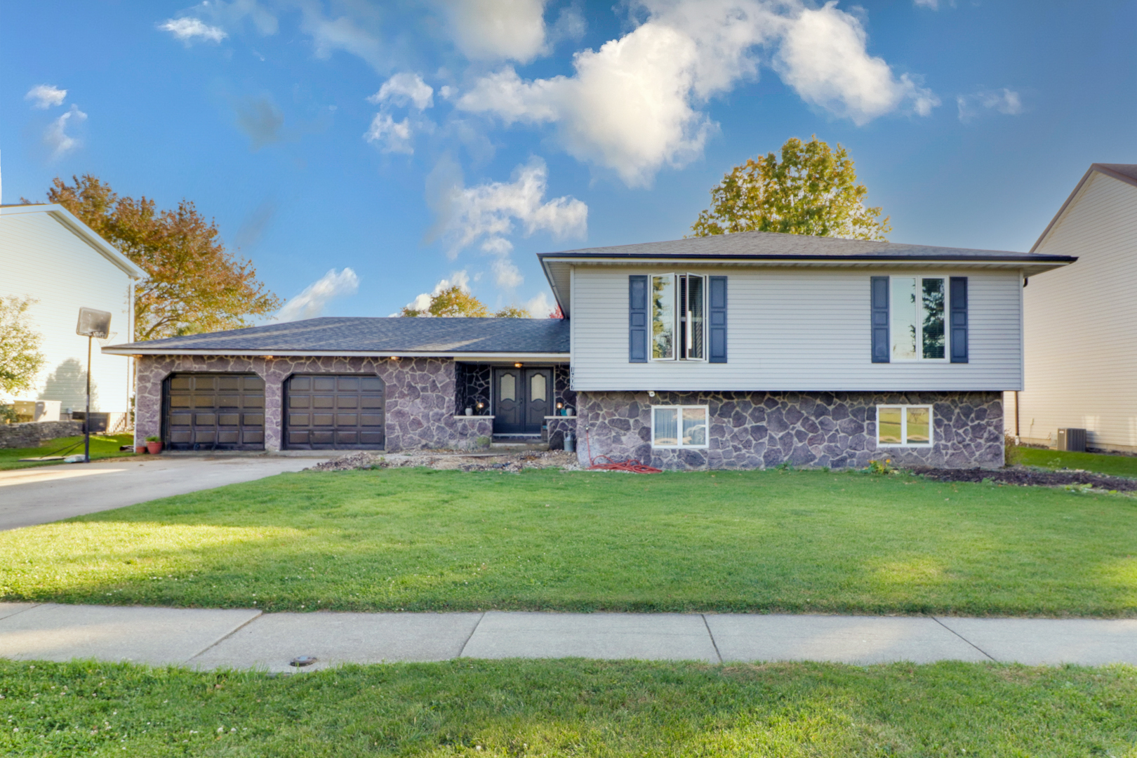 1607 Gregory Street Normal, IL 61761 - Photo 1 of 32 a view of a yard in front of a house with plants and large tree