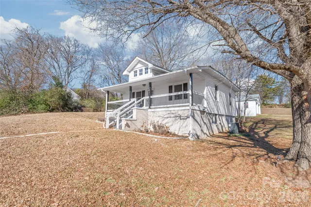 a view of house with yard and covered with snow