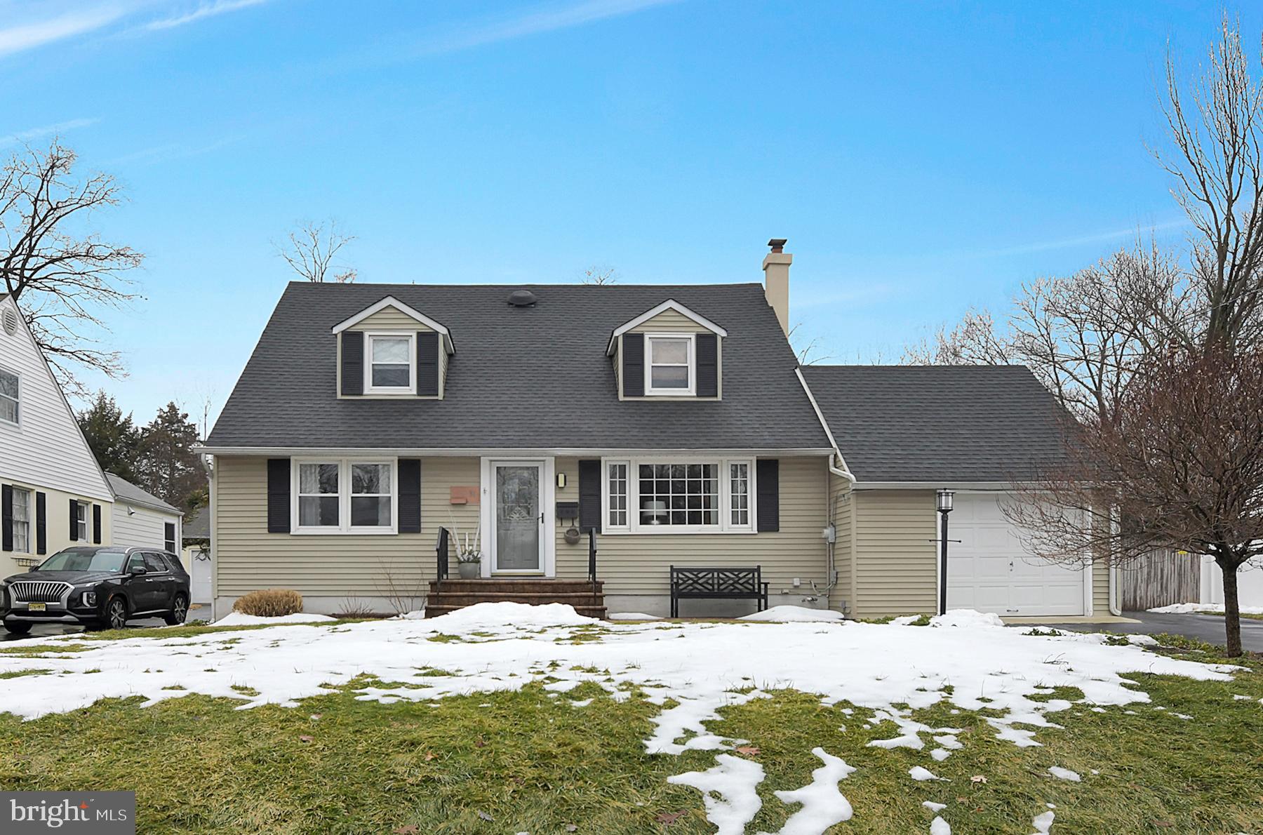 56 Ridgewood Avenue Ewing, NJ 08618 - Photo 1 of 28 a front view of a house with a yard covered in snow
