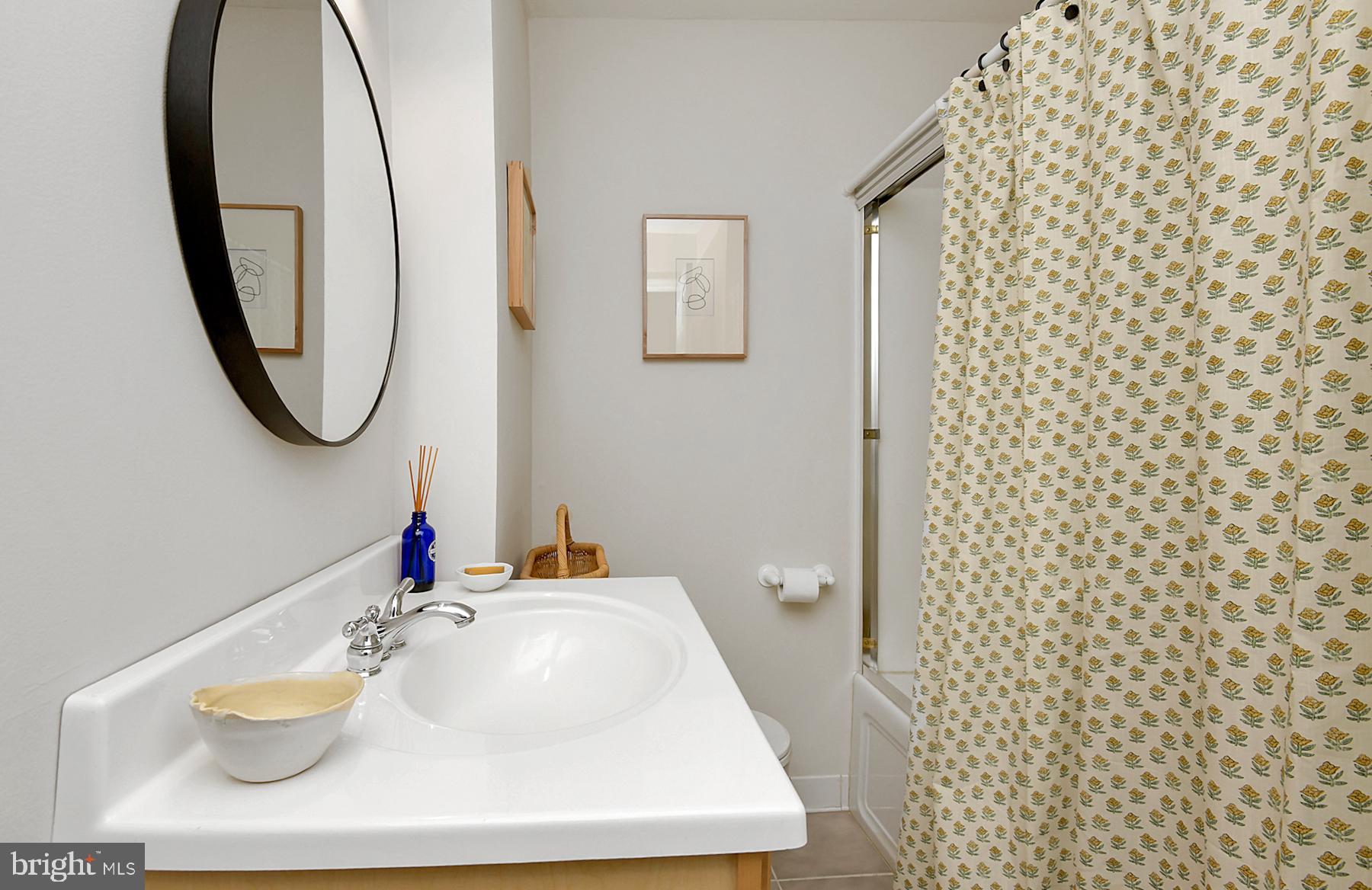56 Ridgewood Avenue Ewing, NJ 08618 - Photo 18 of 28 a bathroom with a sink a toilet and a mirror
