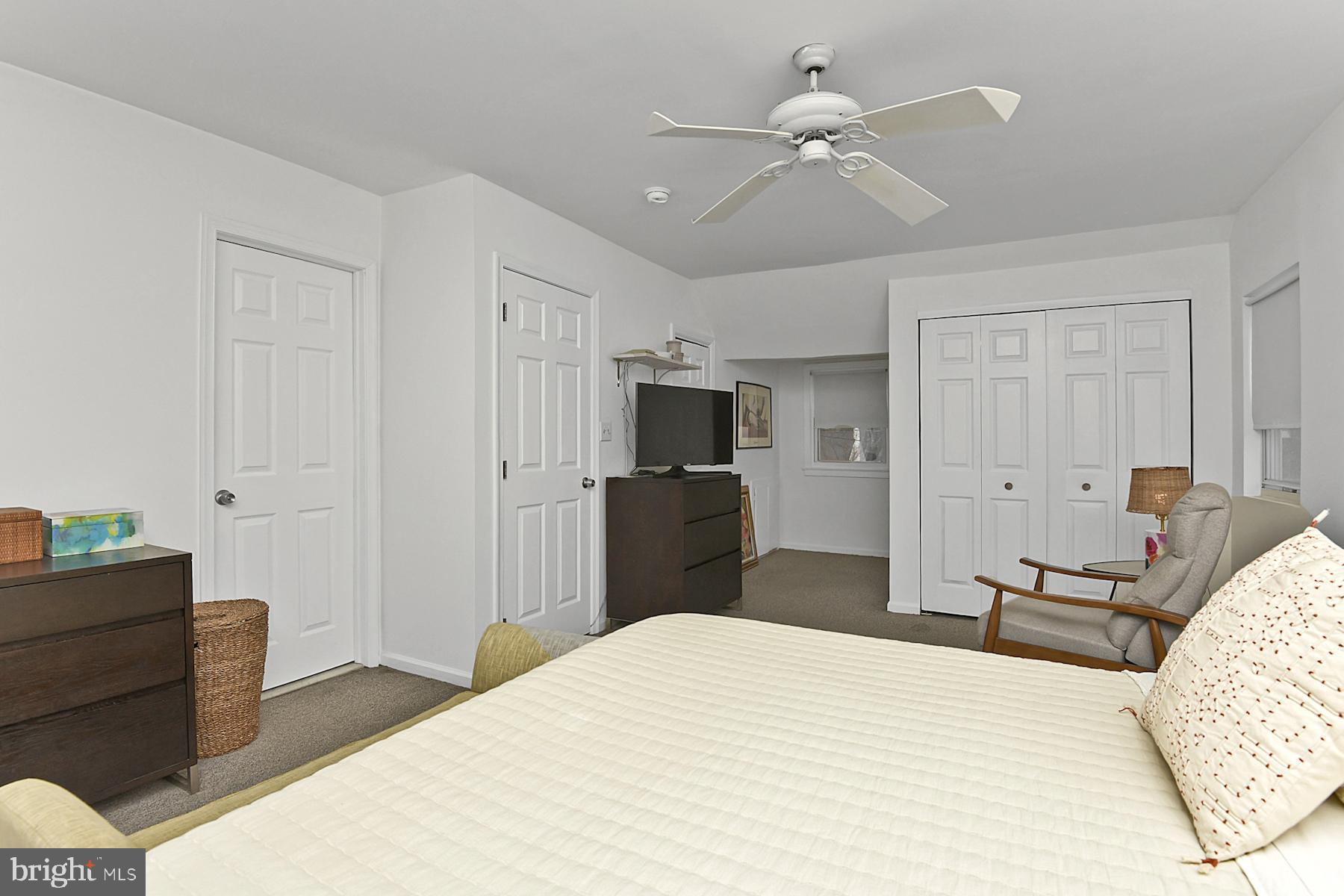 56 Ridgewood Avenue Ewing, NJ 08618 - Photo 20 of 28 a bedroom with a bed and a chandelier