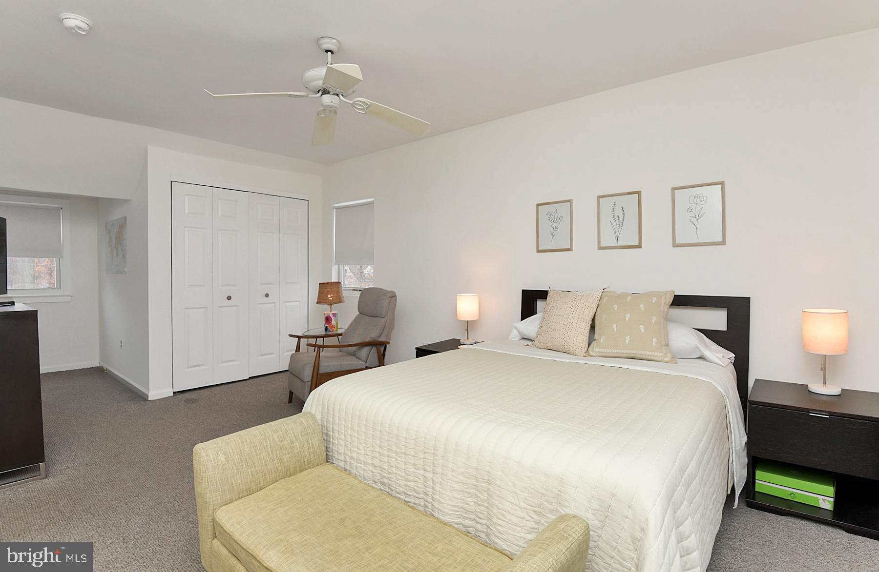 56 Ridgewood Avenue Ewing, NJ 08618 - Photo 21 of 28 a bedroom with a bed and a chandelier