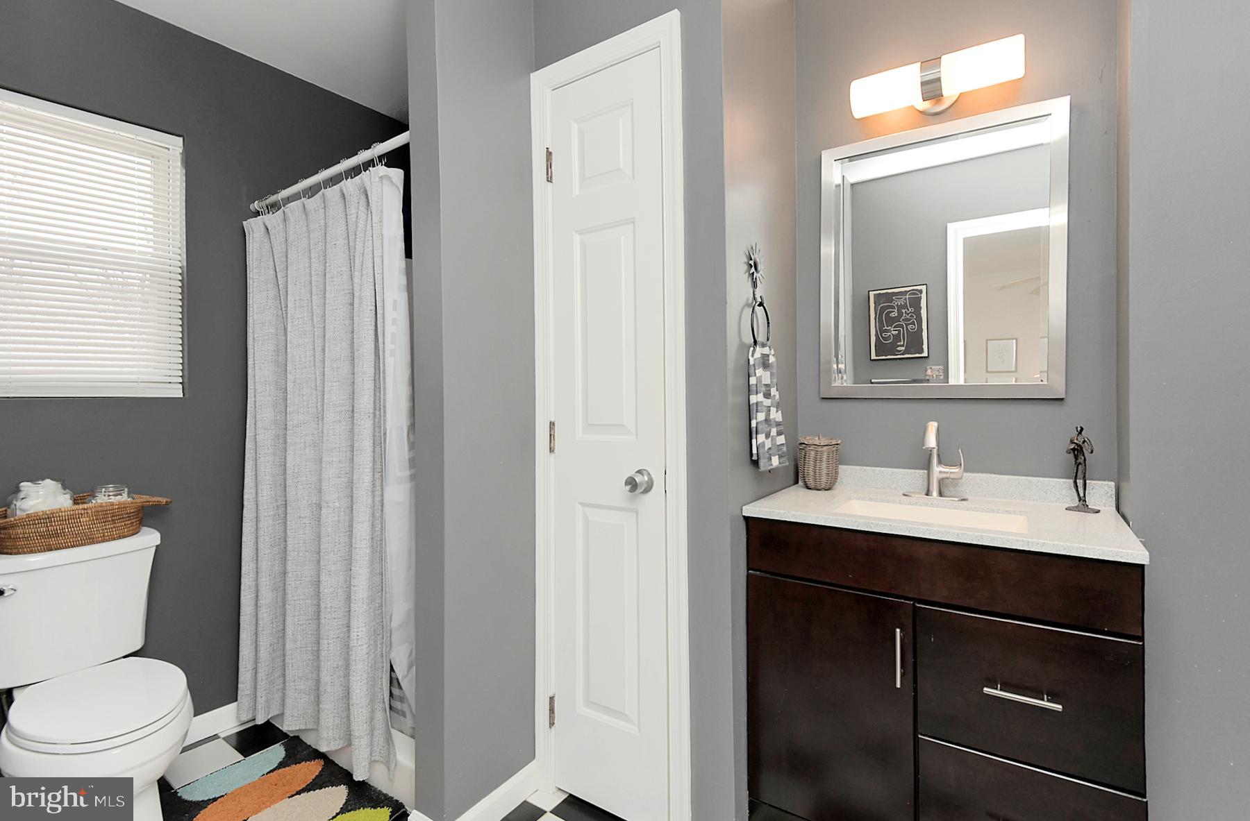56 Ridgewood Avenue Ewing, NJ 08618 - Photo 22 of 28 a bathroom with a toilet a sink and a mirror