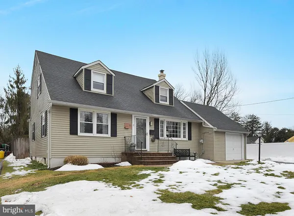 a front view of a house with a yard covered in snow