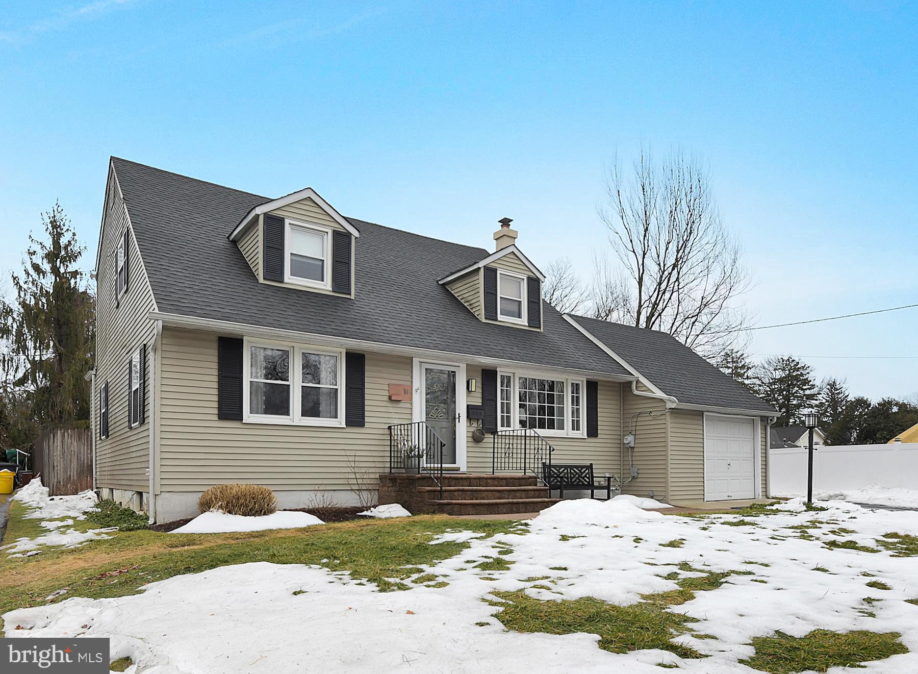 56 Ridgewood Avenue Ewing, NJ 08618 - Photo 3 of 28 a front view of a house with a yard covered in snow