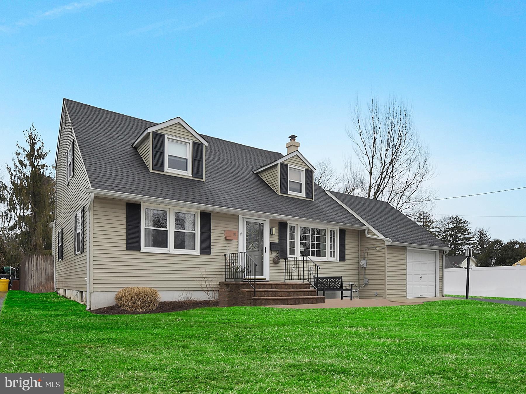 56 Ridgewood Avenue Ewing, NJ 08618 - Photo 4 of 28 a front view of a house with a yard and garage