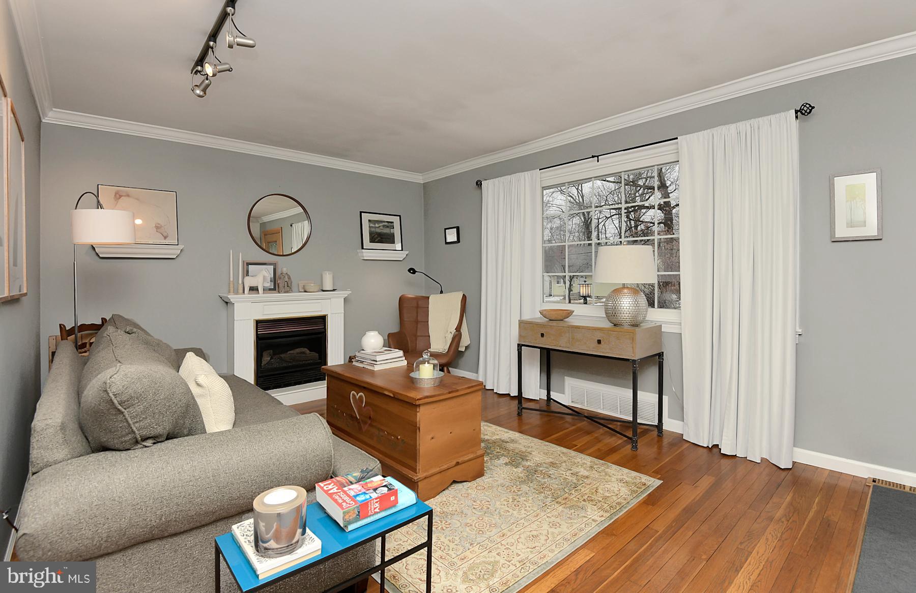 56 Ridgewood Avenue Ewing, NJ 08618 - Photo 7 of 28 a living room with furniture a table and a fireplace