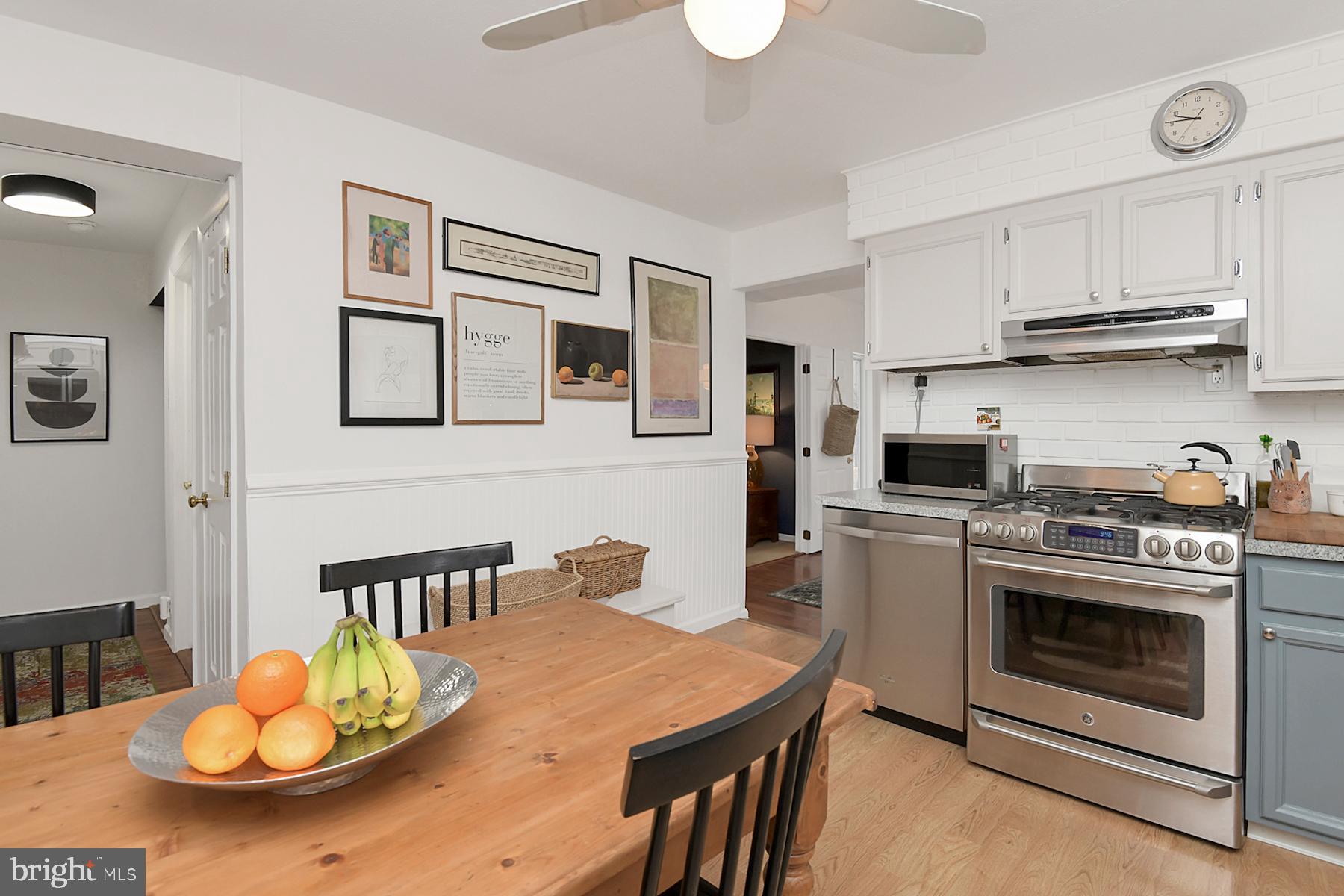 56 Ridgewood Avenue Ewing, NJ 08618 - Photo 9 of 28 a kitchen with stainless steel appliances a stove a kitchen island a stove a table and chairs